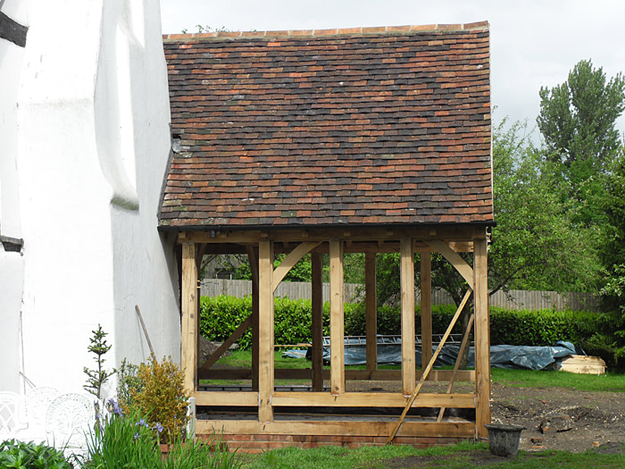 New oak framed garden room extension covered using reclained peg tiles
